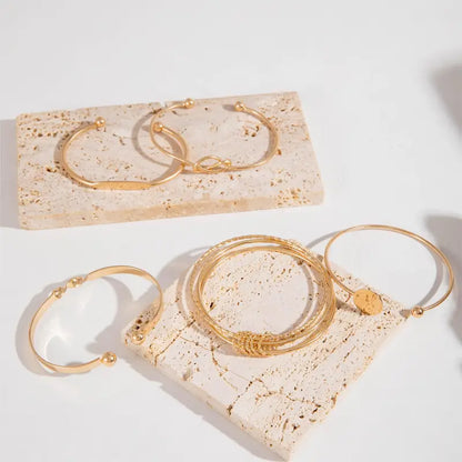 Conjunto Cinco Pulseiras Rígidas com Nó e Disco